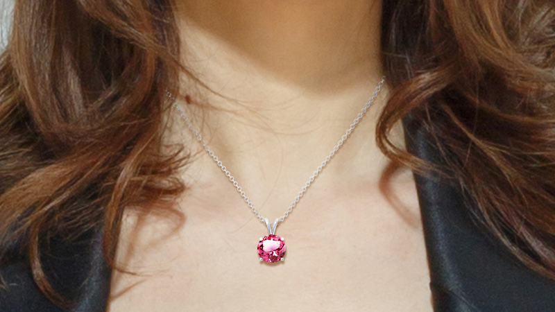 A woman wearing pink tourmaline pendant