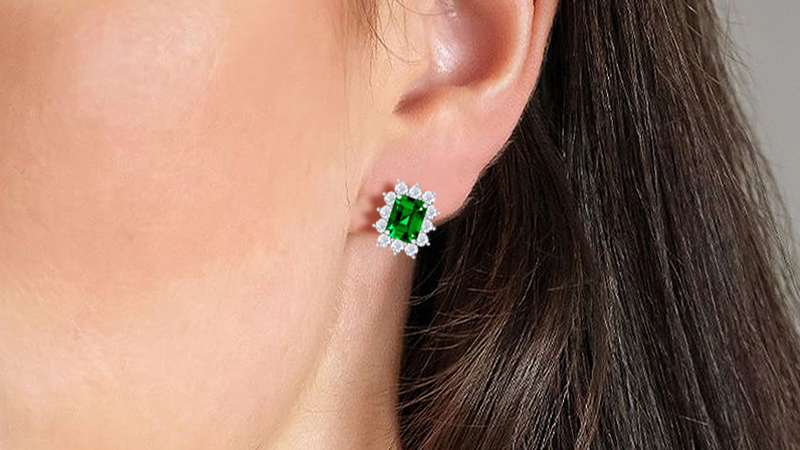 woman wearing emerald earrings