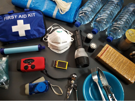 A blue colored first aid kit placed on a table. 